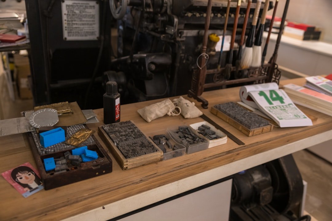 Collection of precision measuring instruments laid out on a machinist's granite surface plate including gauge blocks, indicators, and specialized measuring tools