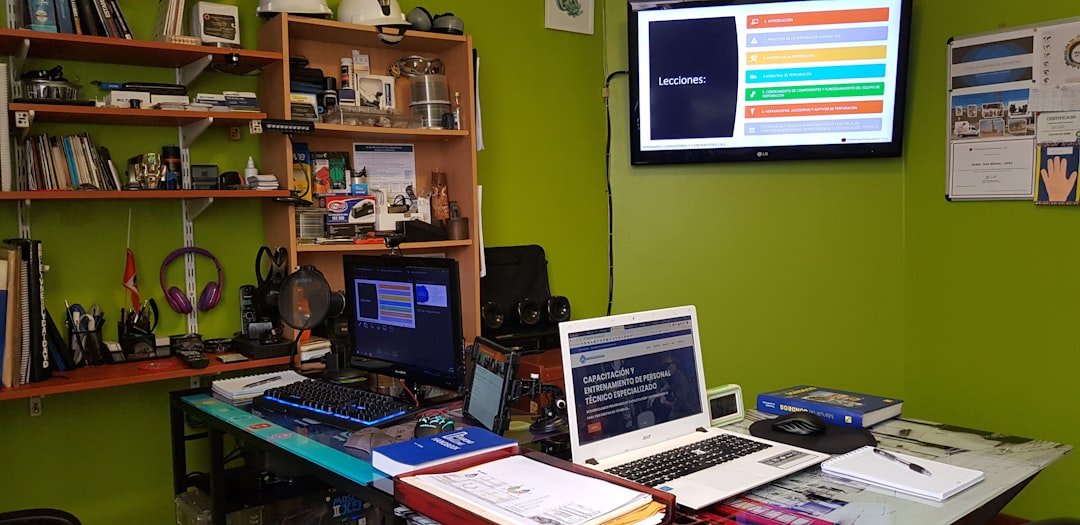 CNC machinist programming toolpaths on CAM software workstation in small job shop