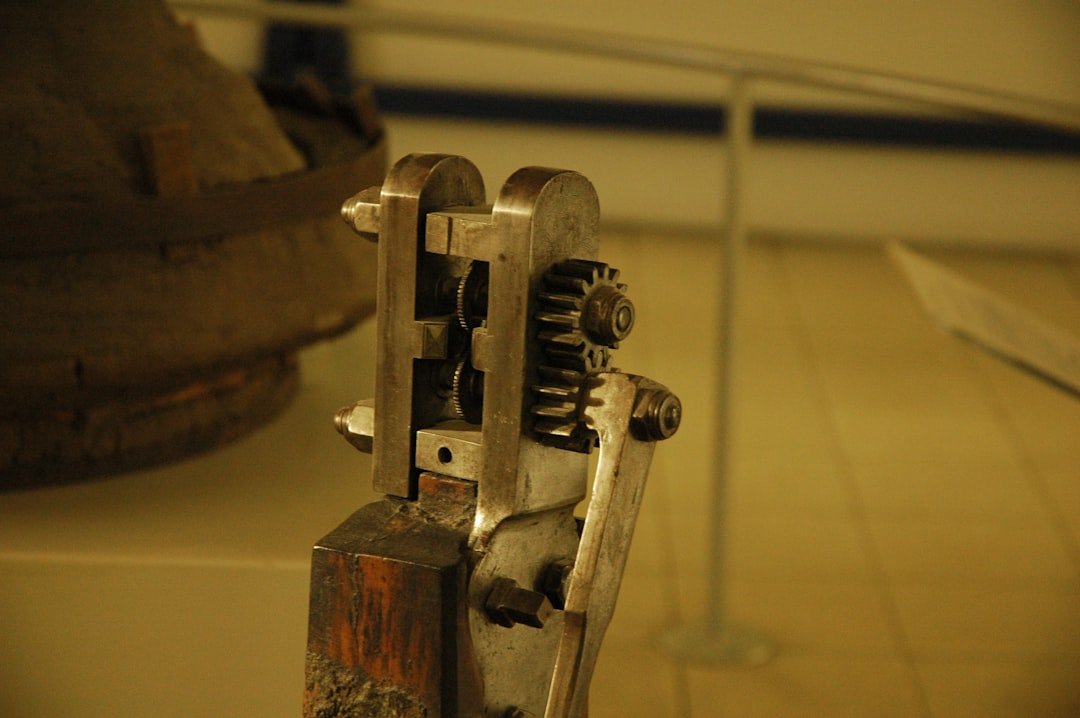 Side-by-side view of a collaborative robot welding cell and a traditional industrial robot welding cell in a fabrication shop