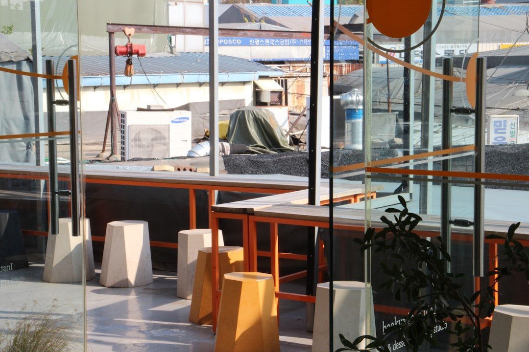 Small modern fabrication shop with specialized CNC equipment and organized workspace